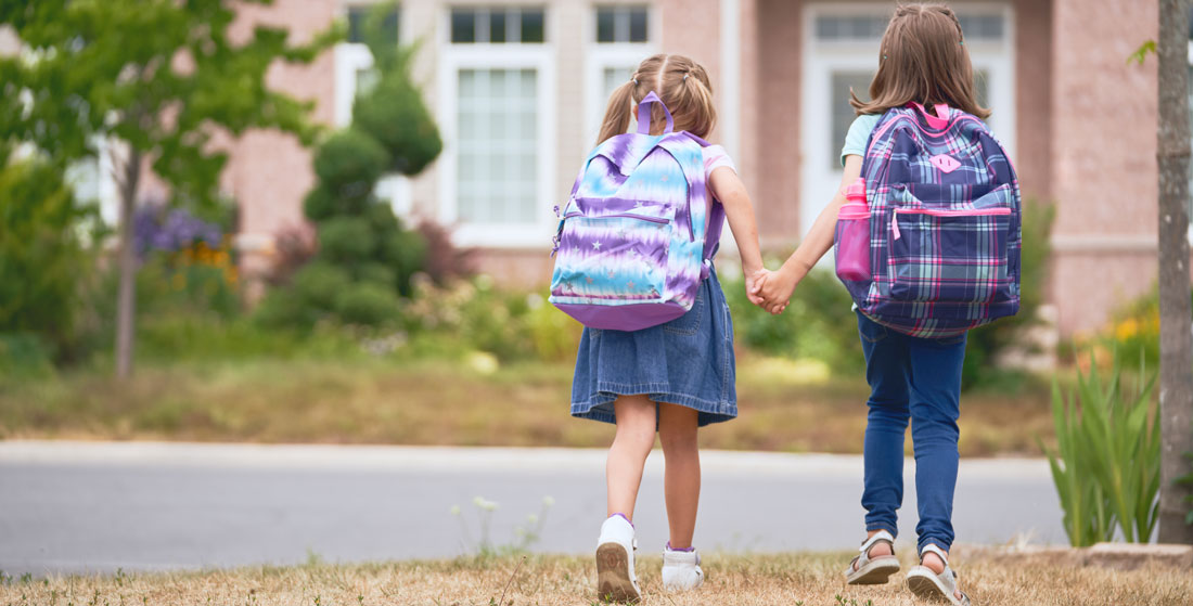 school girls wearing backpacks