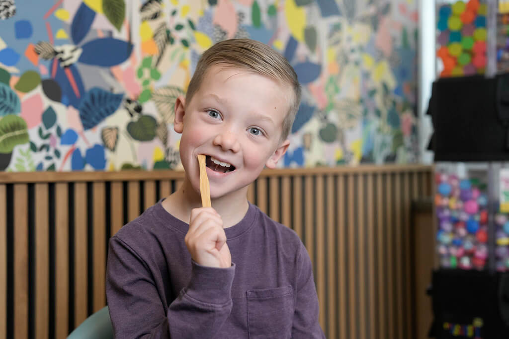 Boy excitedly brushing his teeth