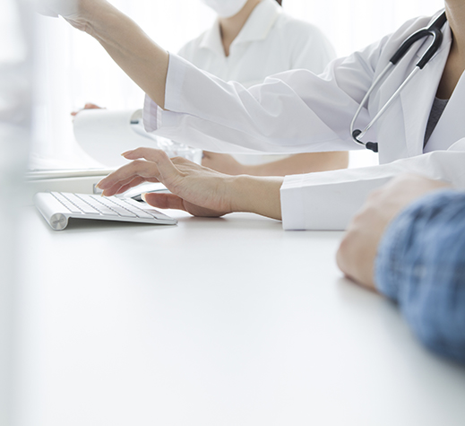 Close-up of physicians meeting around a computer screen