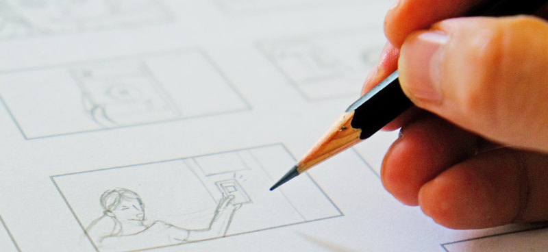 Close-up of a hand drawing a storyboard for a digital marketing video